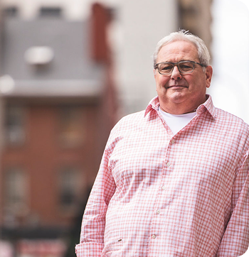 Terry, light-skinned and masculine-presenting, looks at the camera. Terry is a real person taking Wegovy since 2022.