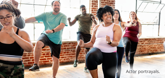 A group of people of various ages and backgrounds take an exercise class. Actor portrayals.​