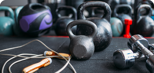 Various types of exercise equipment on a gym floor.
